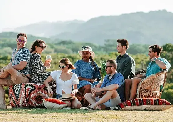 group hanging out on cushions on grass