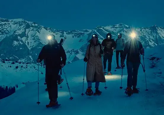 snowshoeing by headlamp in snow