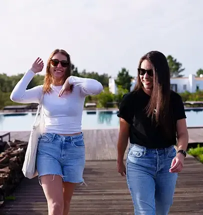two women walking down pier